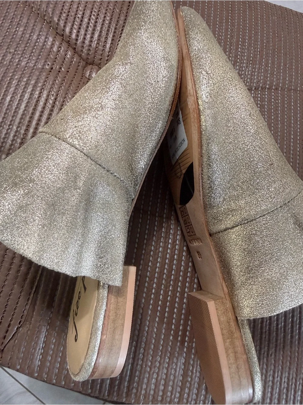 Free People metallic gold pointed-toe mule.